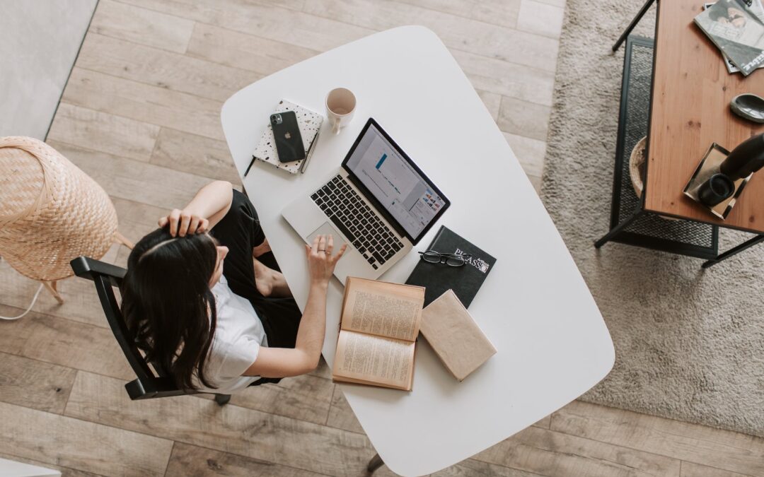 young lady using laptop at table in modern workspace